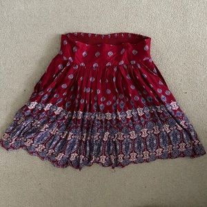 Red patterned pleated skirt.